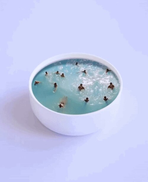 Image of a cup like a pool and people inside it