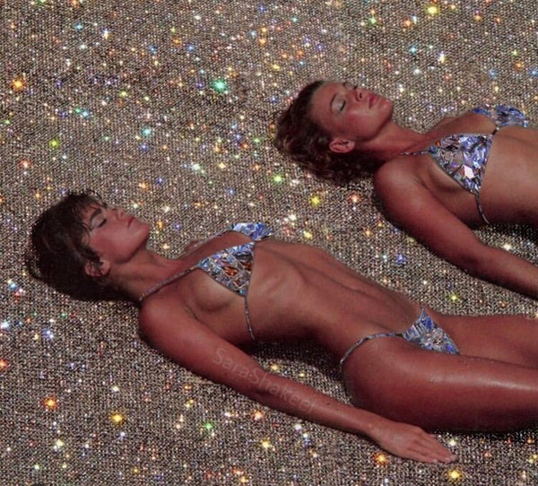 Two women on the beach in the bikinis